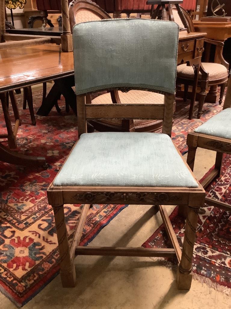 A set of six 1920's oak dining chairs two with arms